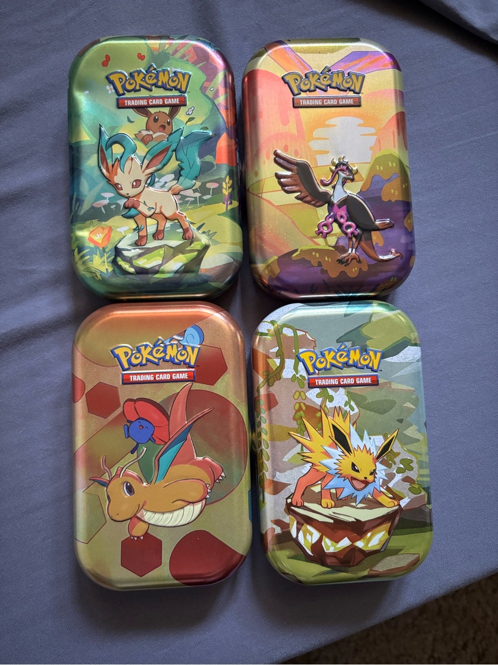 Pokemon Tin Set with Green, Yellow, Orange, Purple Artwork